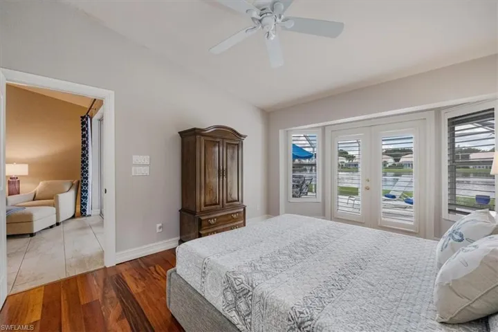 Master Bedroom View 2 featuring vaulted ceiling, ceiling fan, access to outside, and cherry hardwood  flooring
