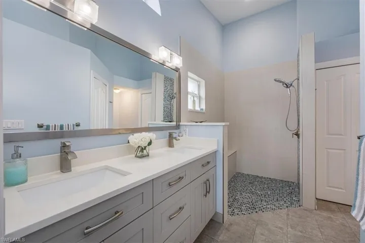 Master Bathroom featuring vanity, a shower, and tile patterned flooring