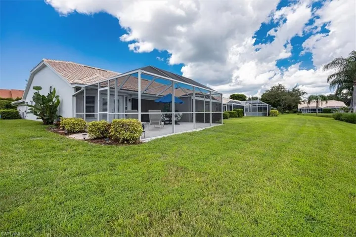 Back of property featuring a patio, yard, and screened lanai