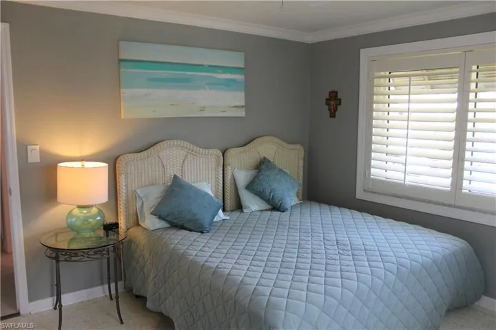 Bedroom featuring ornamental molding and a ceiling fan