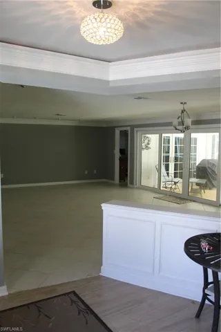 Kitchen featuring a chandelier and baseboards