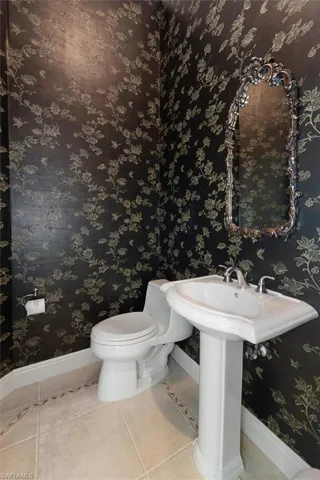 Half bathroom with tile patterned floors and toilet