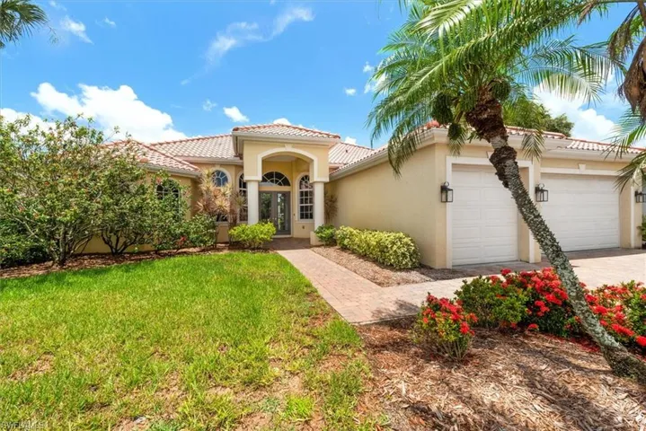 Mediterranean / spanish house with stucco siding, a garage, a front yard, a tiled roof, and concrete driveway