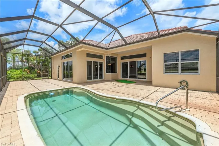Outdoor pool with a patio area and a lanai