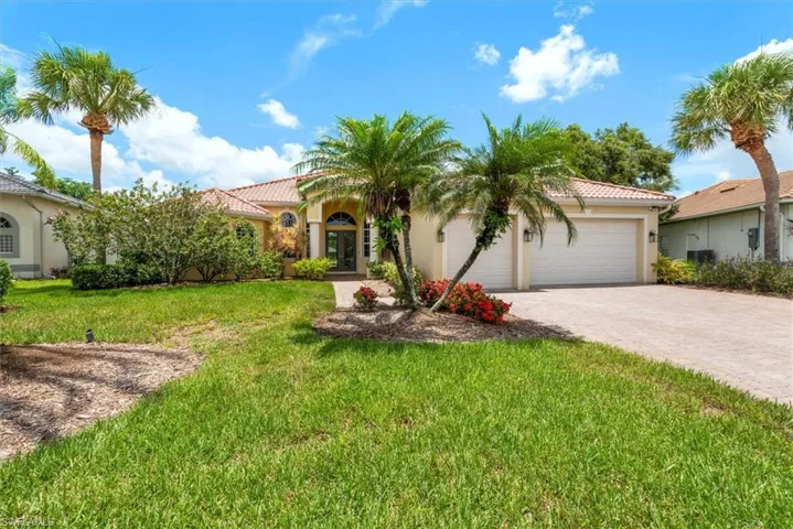 Mediterranean / spanish-style house with stucco siding, a tiled roof, driveway, a garage, and a front yard