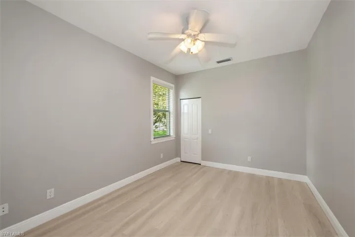 Empty room featuring light wood-style floors and ceiling fan