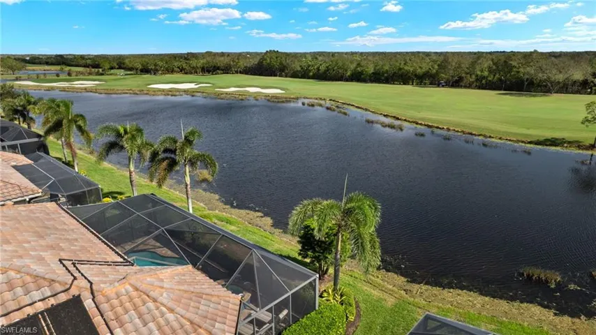 Birds eye view of property with a water view