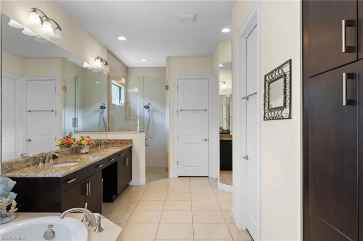 Bathroom with vanity, separate shower and tub, and tile patterned floors