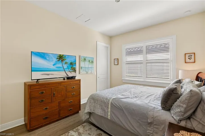 Bedroom with light hardwood / wood-style flooring