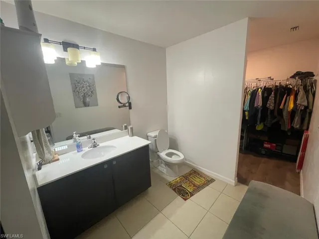 Bathroom with tile patterned floors, toilet, and vanity