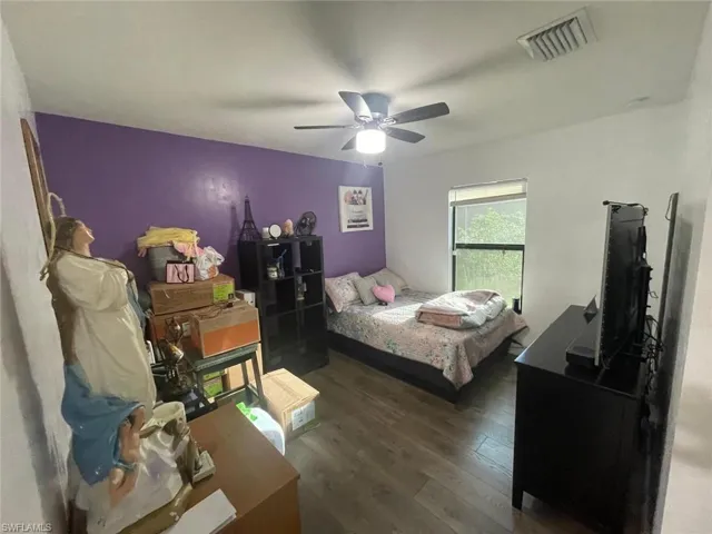 Bedroom featuring ceiling fan and hardwood / wood-style floors