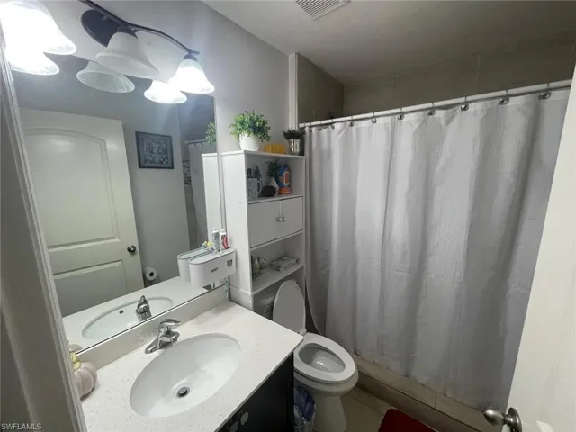 Bathroom with tile patterned flooring, toilet, and vanity