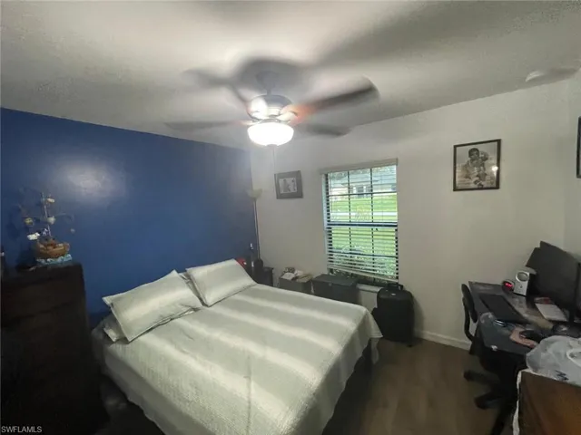 Bedroom featuring ceiling fan and wood-type flooring