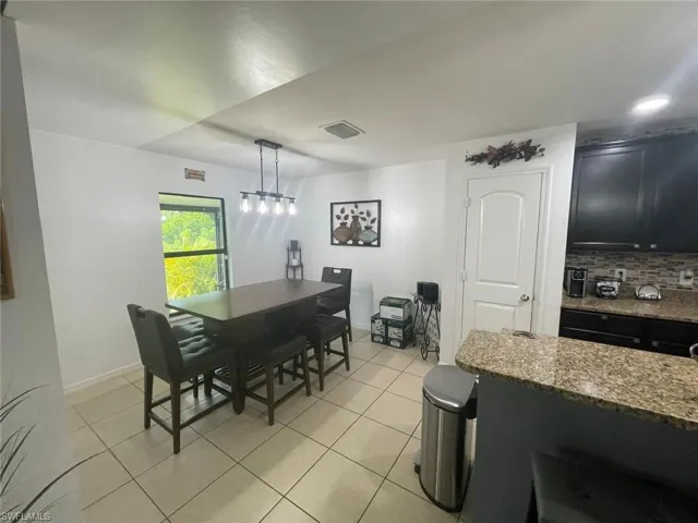 Dining area featuring light tile patterned floors