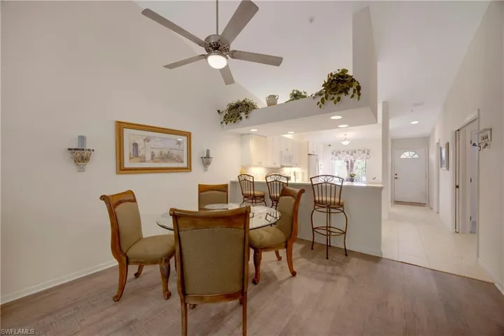 Dining room featuring baseboards, a ceiling fan, and light wood finished floors