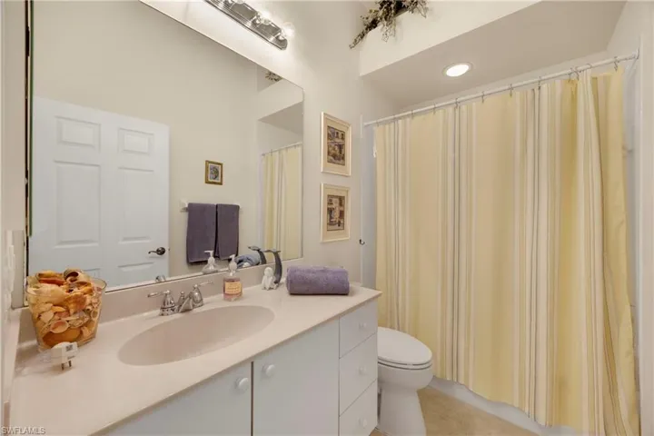 Full bathroom featuring tile patterned flooring, toilet, and vanity