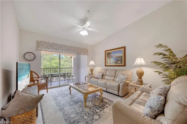 Living area featuring ceiling fan and lofted ceiling