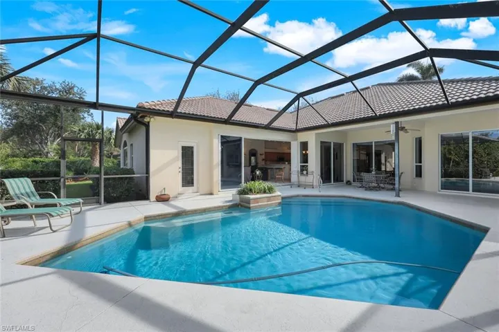 View of pool with a patio, ceiling fan, and a lanai