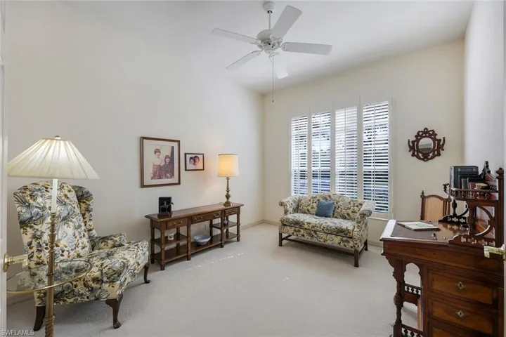 Sitting room featuring ceiling fan and carpet floors