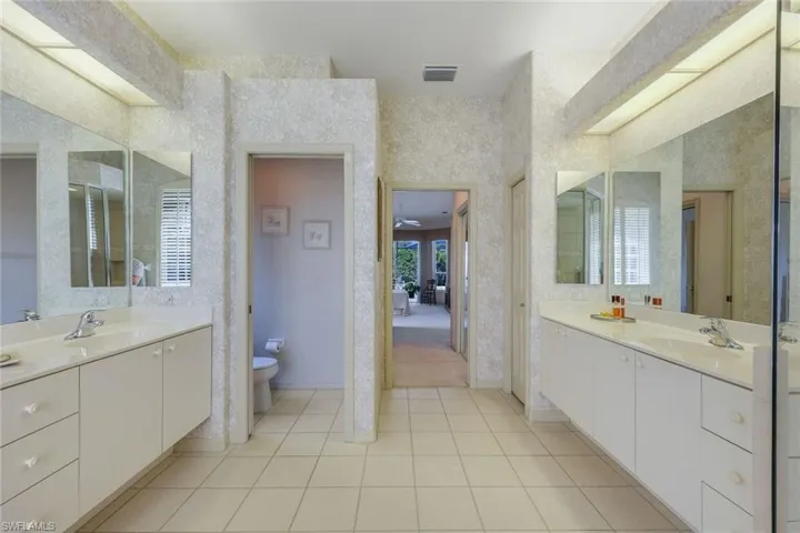 Bathroom featuring tile patterned flooring, vanity, and toilet