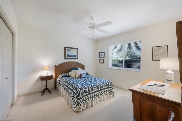 Bedroom featuring ceiling fan, a closet, and light carpet