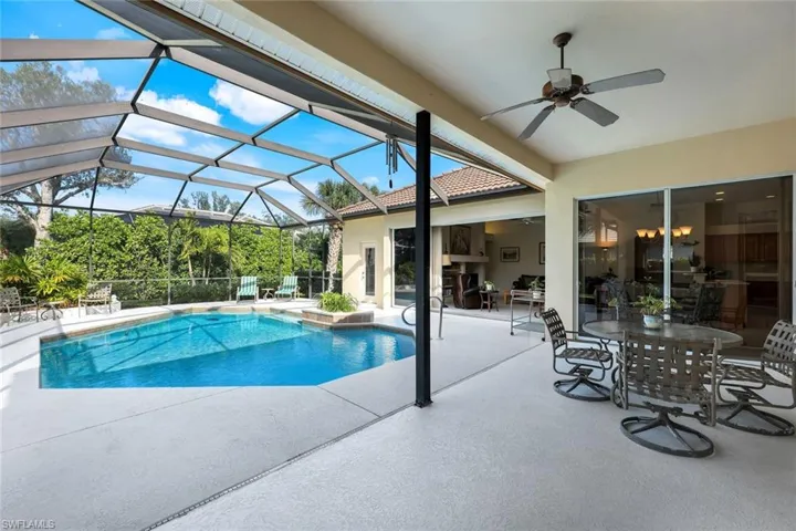 View of pool featuring ceiling fan, a patio area, and a lanai