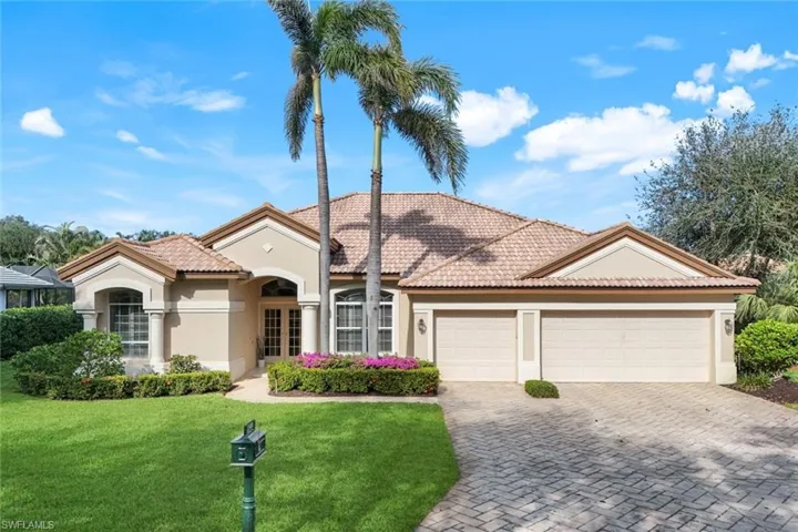 Mediterranean / spanish home with a front lawn and a garage