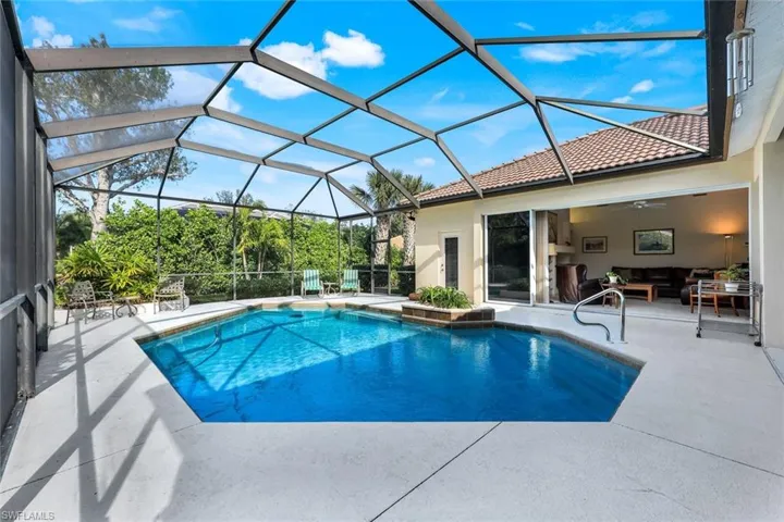 View of swimming pool with outdoor lounge area, a patio area, ceiling fan, and a lanai