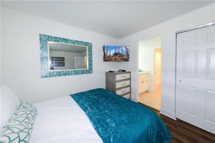 Bedroom featuring wood finished floors and connected bathroom