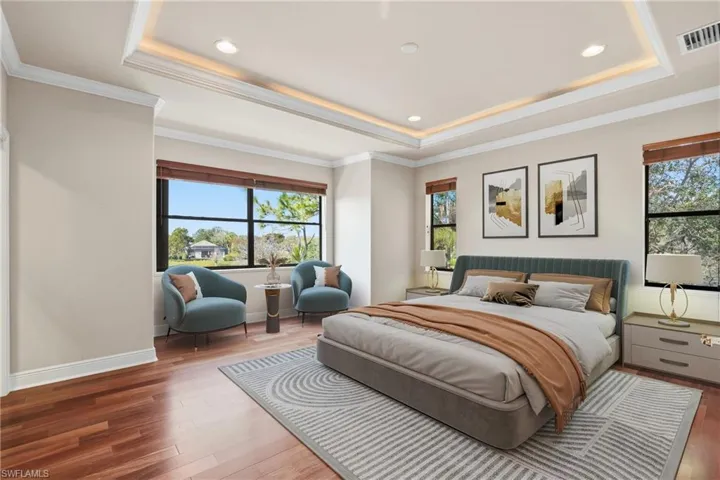 Virtually staged. Bedroom with hardwood / wood-style flooring, crown molding, a raised ceiling, and recessed lighting.