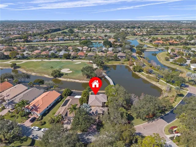 Aerial view highlighting the home’s prime setting with scenic golf course vistas and tranquil lakes just beyond the backyard.