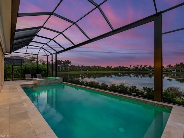 Pool at dusk with panoramic screens overlooking the serene lake gorgeous pink night skies.