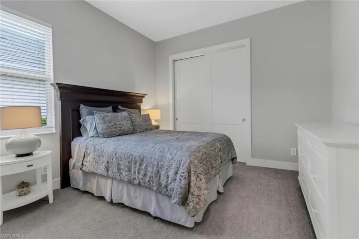 Guest Bedroom (2) with light colored carpet.