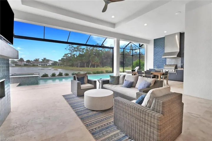Gorgeous patio with custom fireplace, custom kitchen with tiled back splash with panoramic screen enclosure.