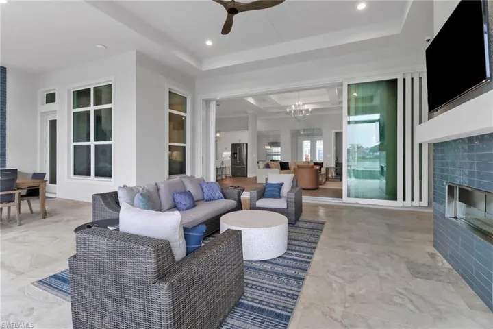 Spacious Stock home outdoor lanai with marble flooring, custom fireplace and plenty of under cover space.