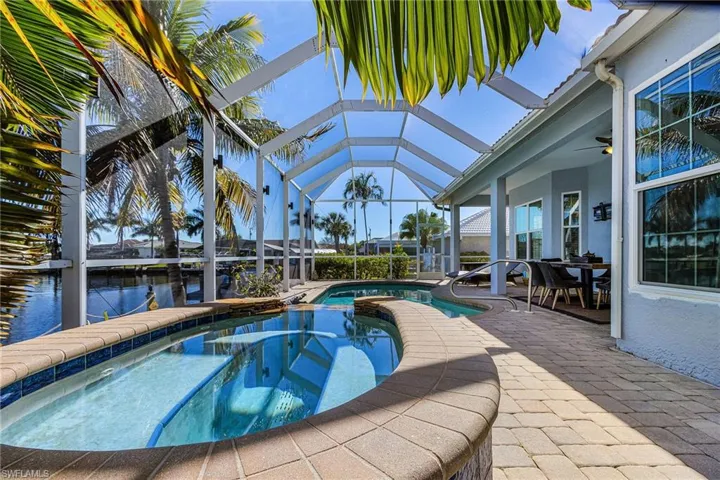 This property features a screened-in lanai with a swimming pool and an integrated spa