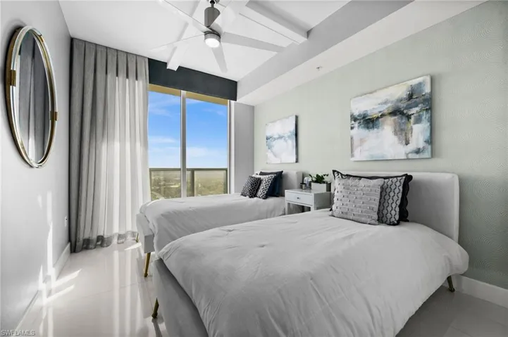 Tiled bedroom featuring ceiling fan
