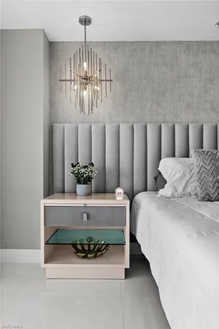 Tiled bedroom with a chandelier