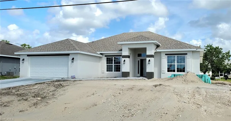 View of front of property with a garage and central air condition unit