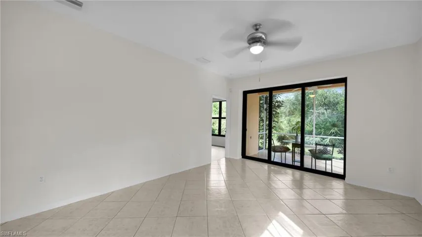 Unfurnished room with ceiling fan and light tile patterned floors
