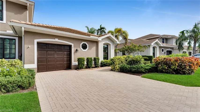 Mediterranean / spanish home featuring stucco siding, a tile roof, and decorative driveway