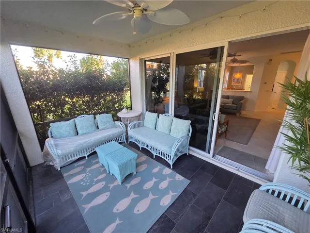 Sunroom with a ceiling fan, outdoor lounge area, and a patio
