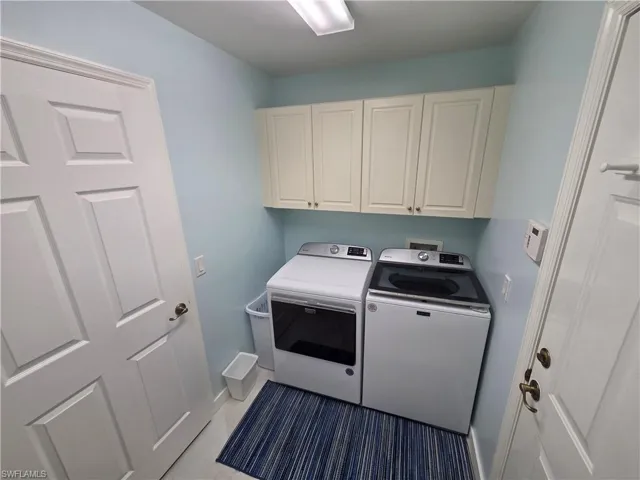Laundry room with independent washer and dryer and cabinet space
