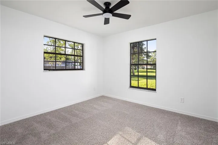 2nd guest bedroom with new carpet flooring and ceiling fan