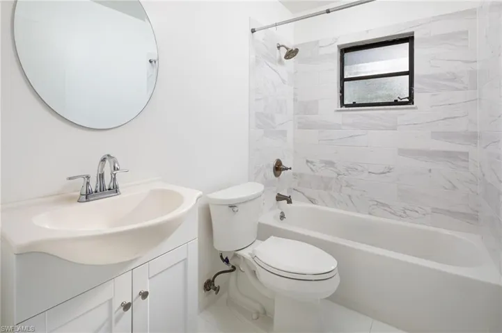 Newly renovated full bath featuring vanity and shower / tub combination