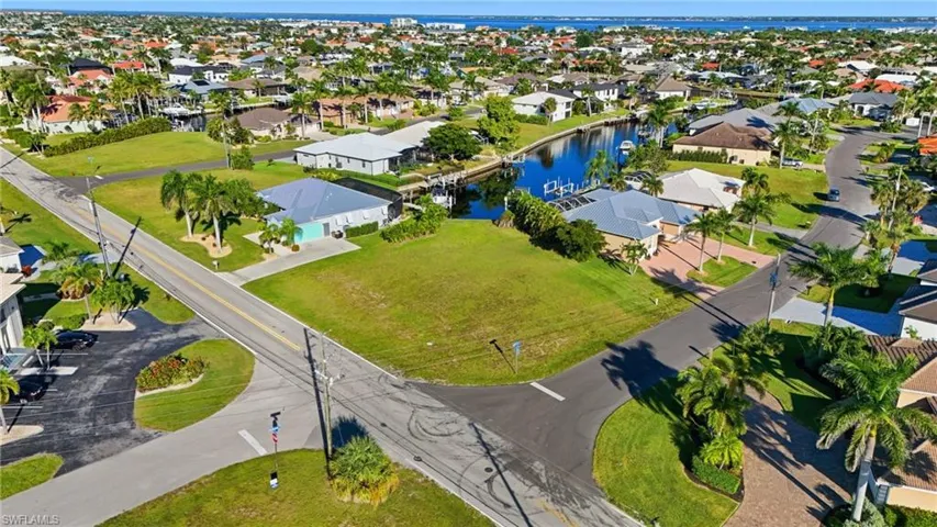 Aerial view of residential area featuring a nearby body of water