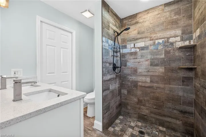Bathroom with double vanity and a tile shower