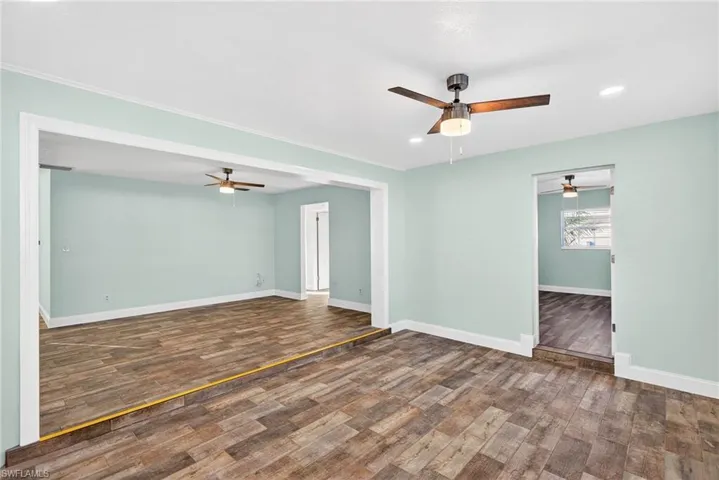Spare room featuring ceiling fan, dark wood-type flooring, and recessed lighting