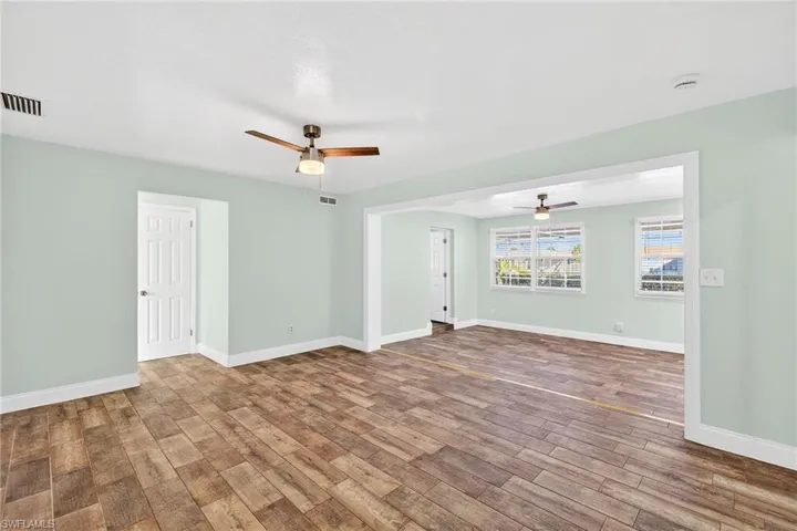 Unfurnished room with ceiling fan and wood finished floors