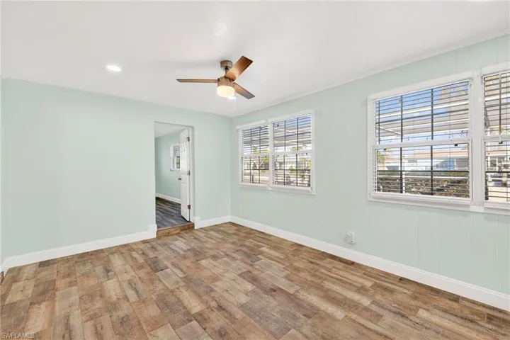 Spare room with light wood finished floors, ceiling fan, and recessed lighting